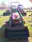 Yl110 Yanmar 221 Tractor With A Mid Mount Mower Deck And Front Bucket Loader
